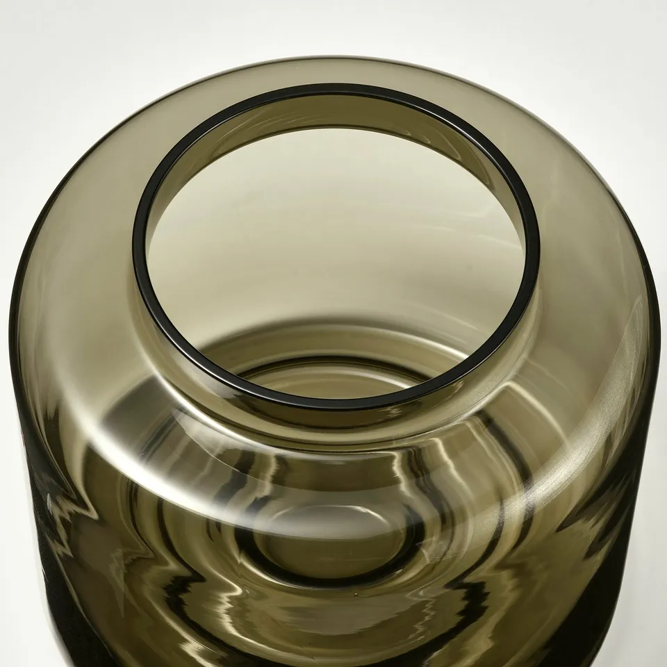 Top view of greenish glass vase, smooth edges, circular opening. Mouth-blown quality seen in textured glass.