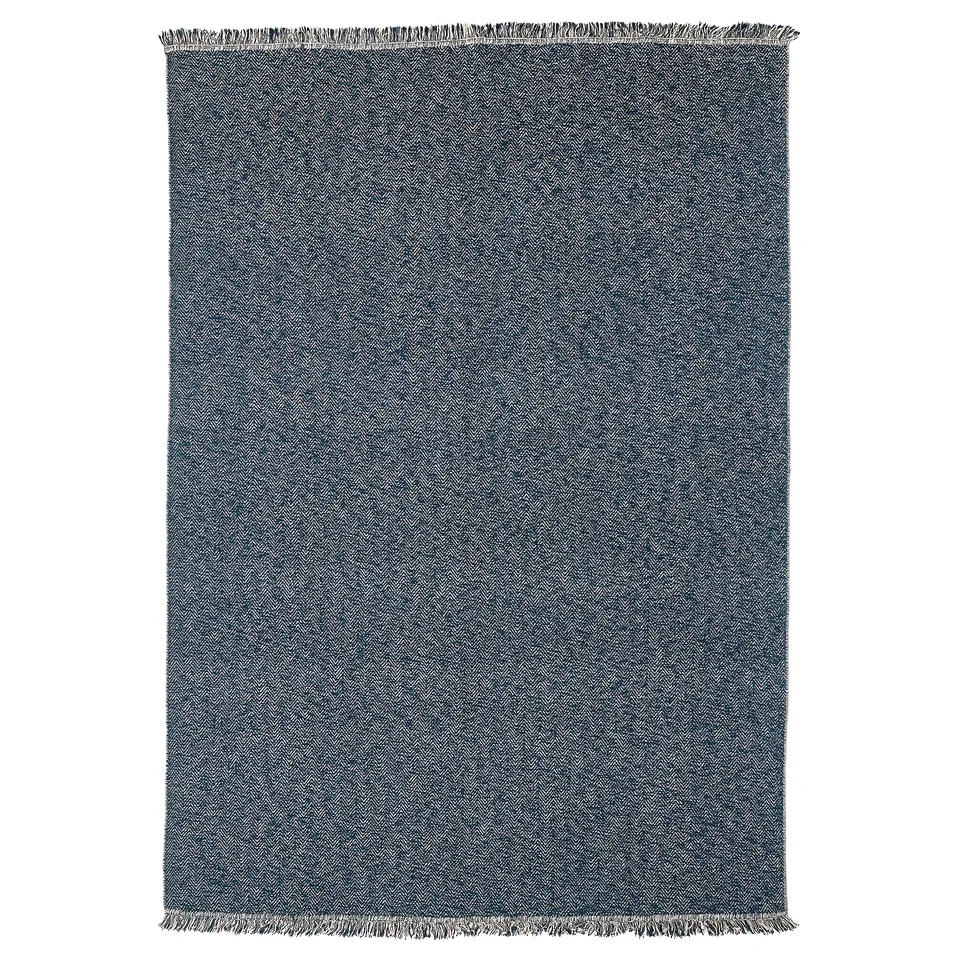 Dark blue rectangular cotton rug with herringbone pattern and fringe on short ends.