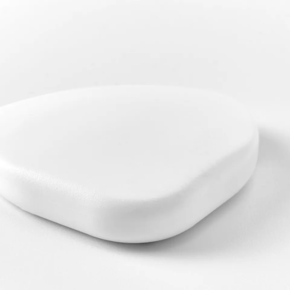 White, smooth corner bumper. Protects edges, maintains sleek look. Designed for safety.