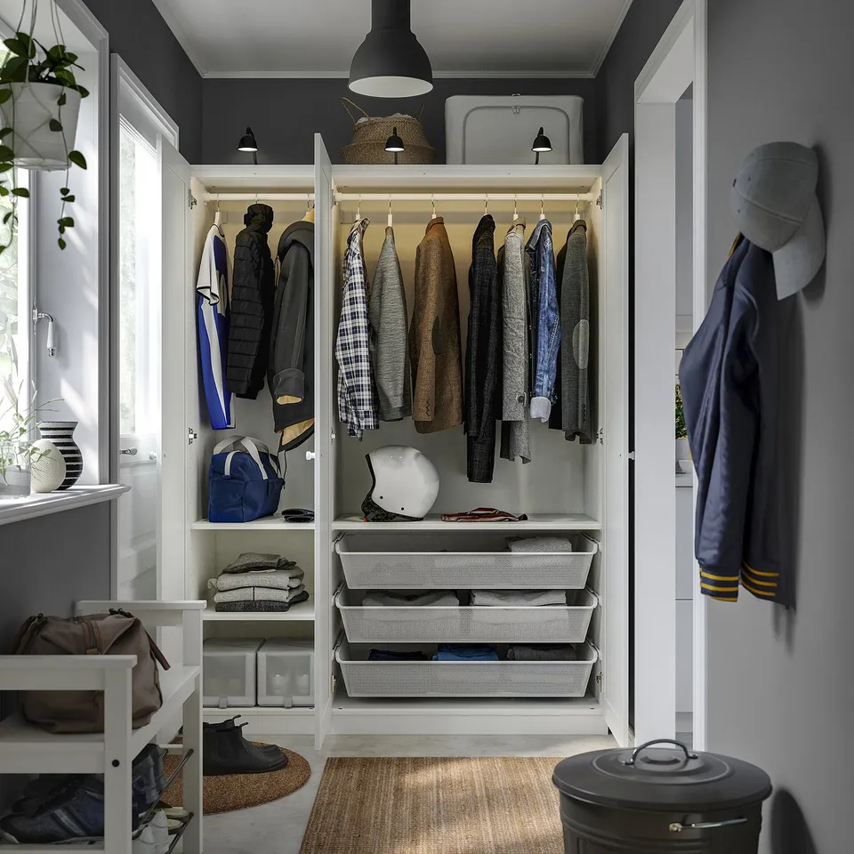 Organised closet with hangers, shelves, and baskets for clothing and accessories.