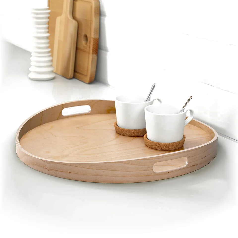 Wooden tray with handles holds two white mugs and coasters on a countertop.