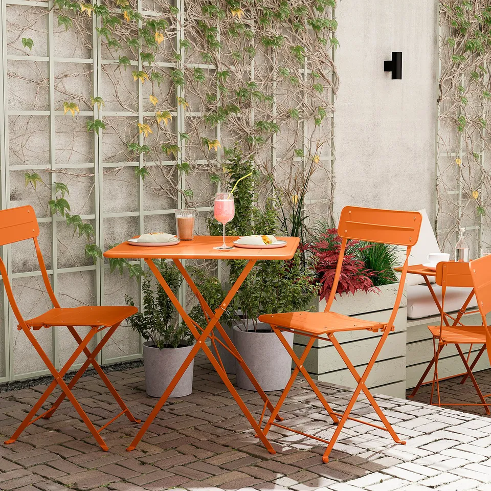 Orange SUNDSÖ balcony set with table & 4 chairs, plants.