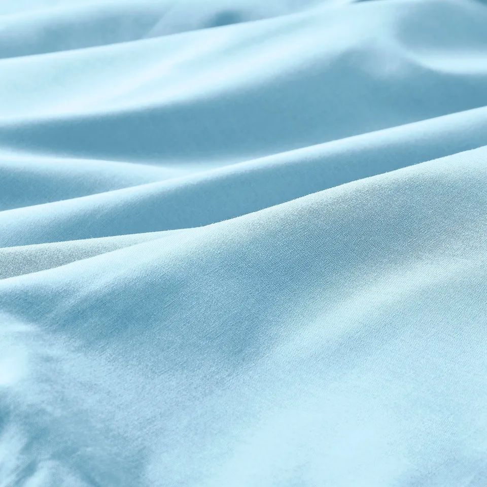 Light blue fabric, smooth texture, soft folds, high quality cotton.