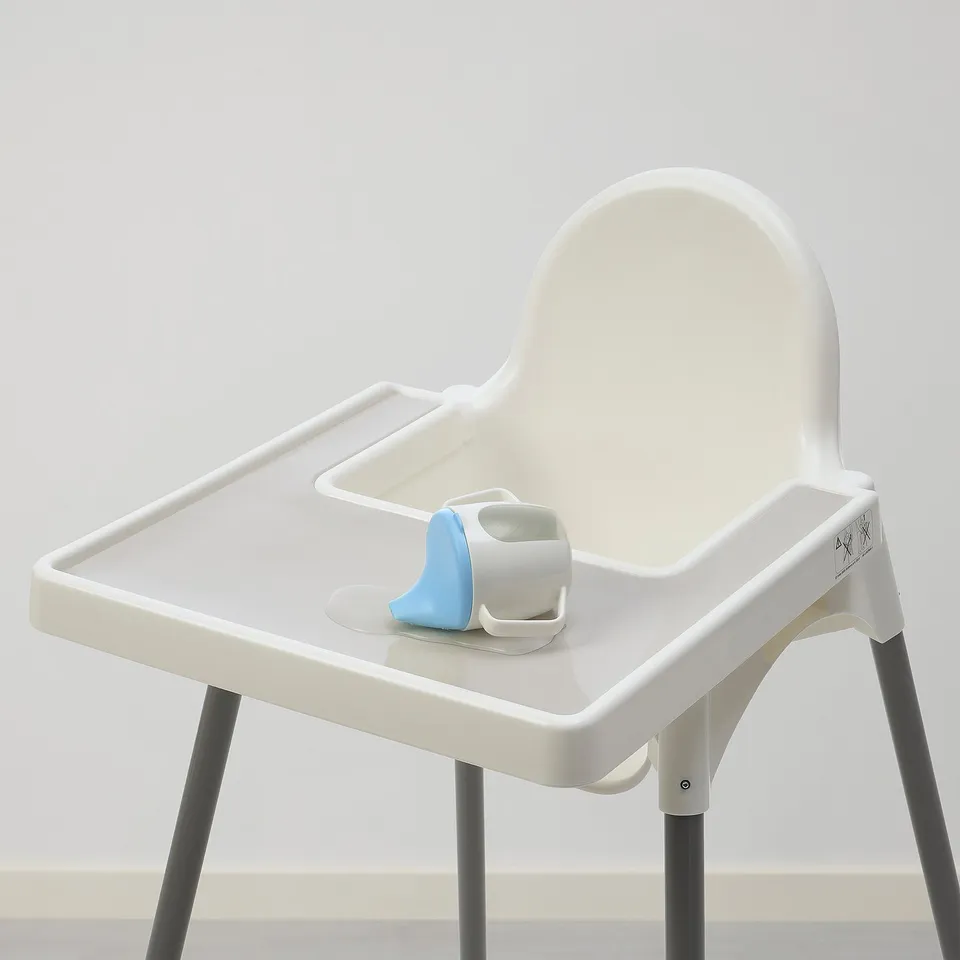 Small white high chair, ANTILOP, with blue silicone place-mat and legs. Suitable for small spaces.