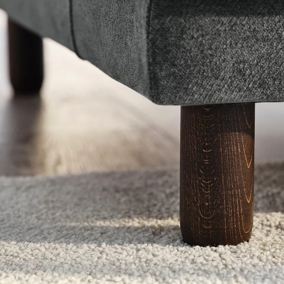 Its a modern sofa with dark wooden legs; soft, durable fabric; and sturdy construction for comfort.