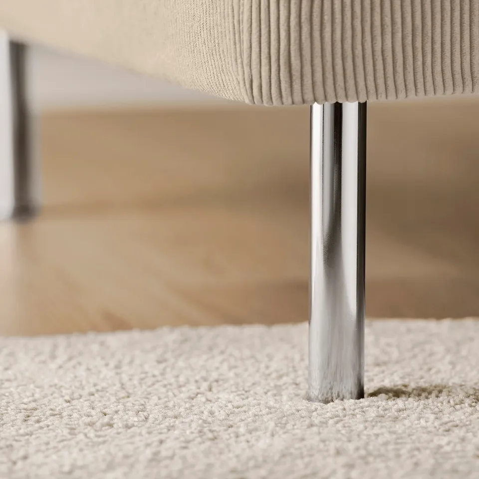 Modern chaise lounge, plush cushion, polished chrome legs. Classic comfort, stylish simplicity.
