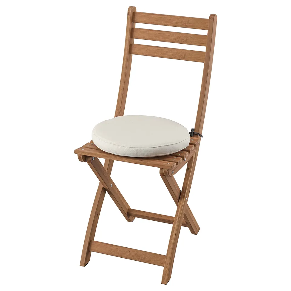 Acacia wood foldable chair with white cushion, ideal for outdoor use.