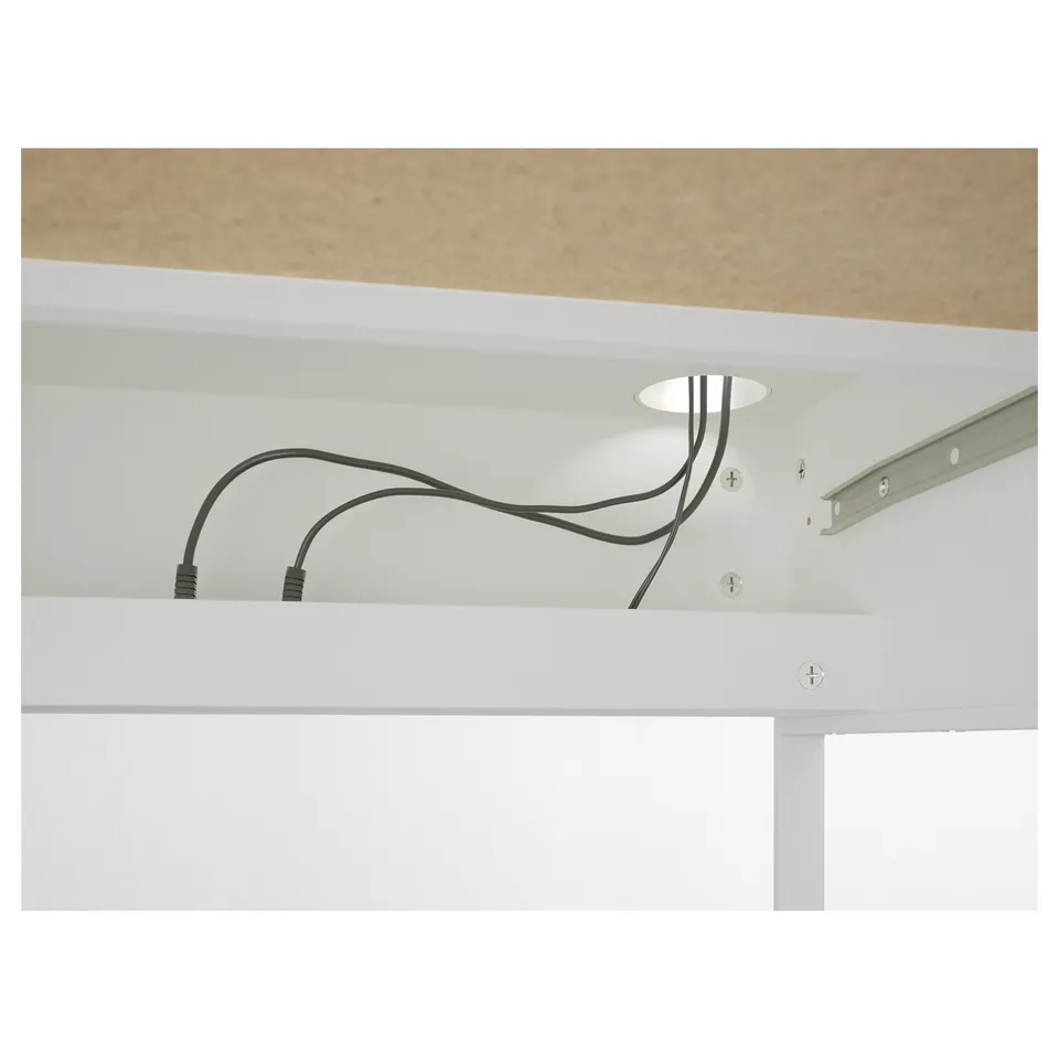 Desk with cable management system, hiding cables at the back.