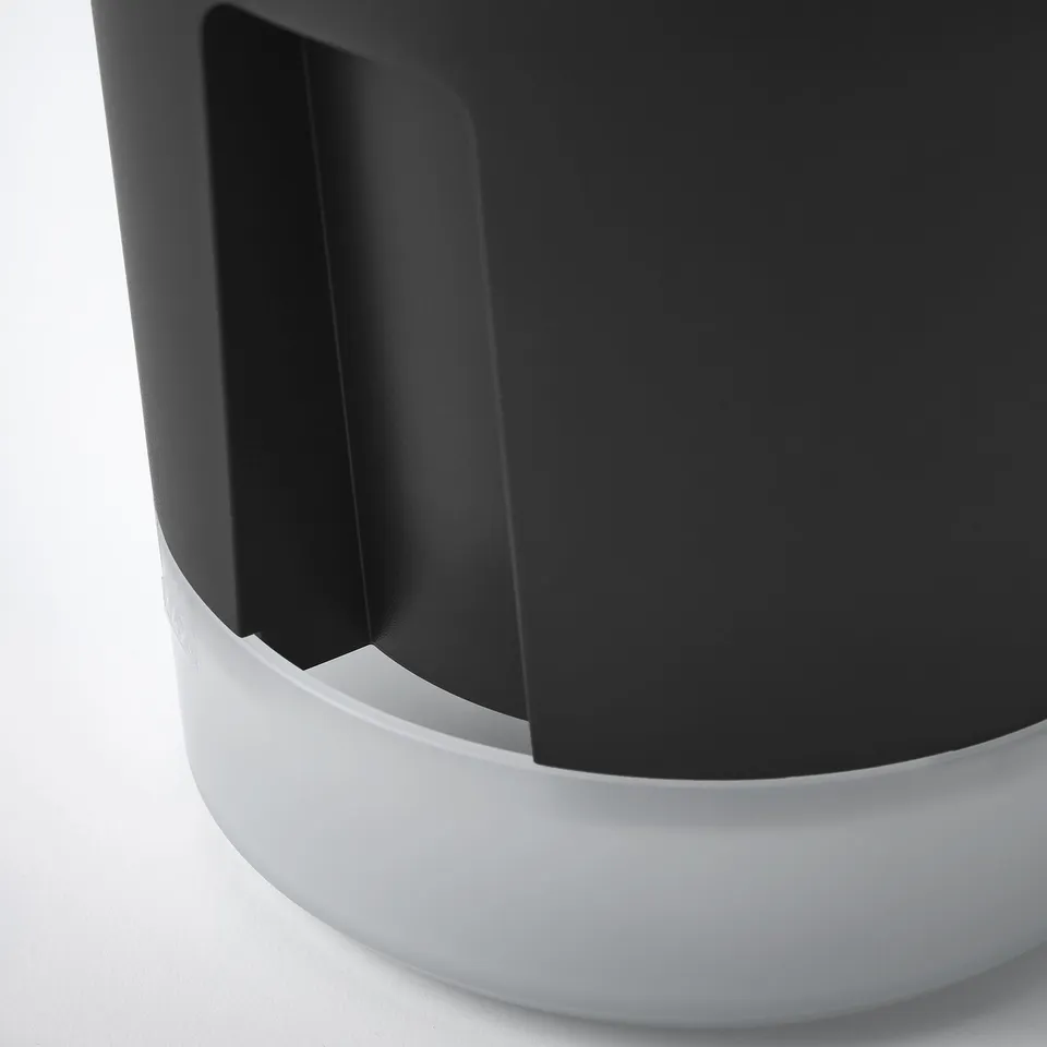 Close-up view of a sleek black and white self-watering planter, showing its modern design and durable materials.