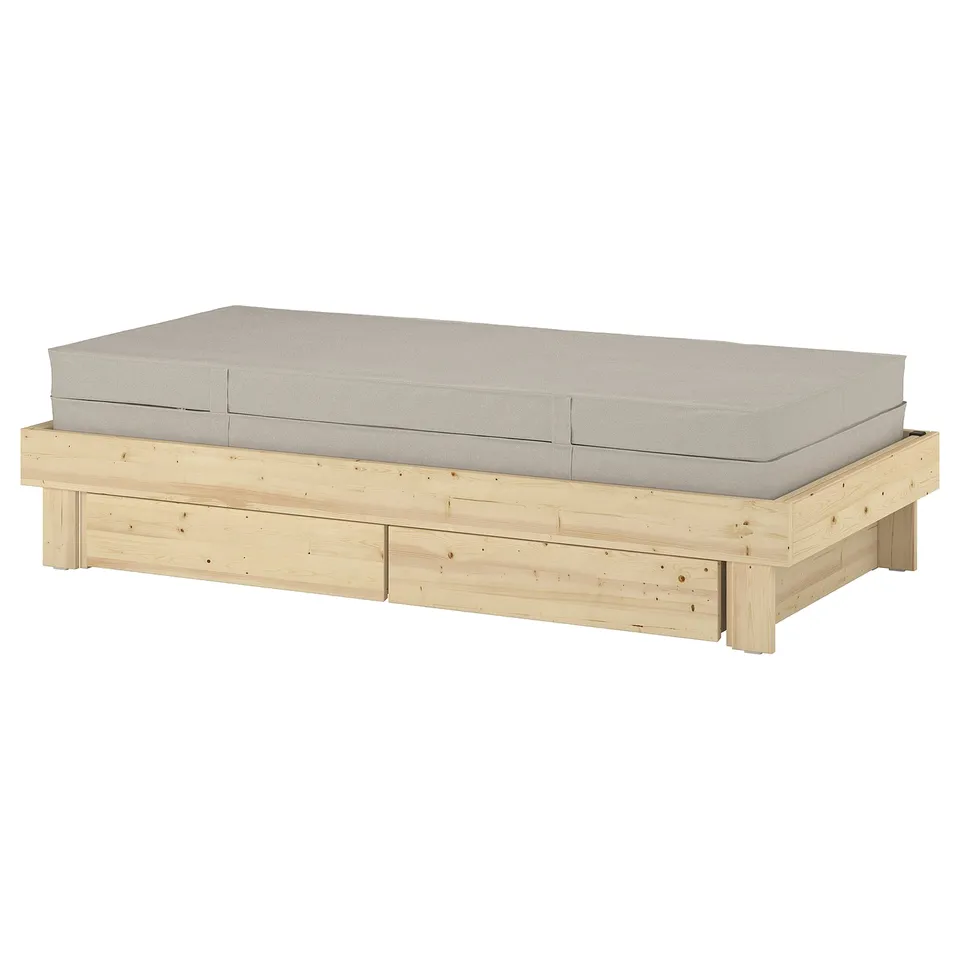 GLAMBERGET extendable bed in beige with wooden base and cushions.