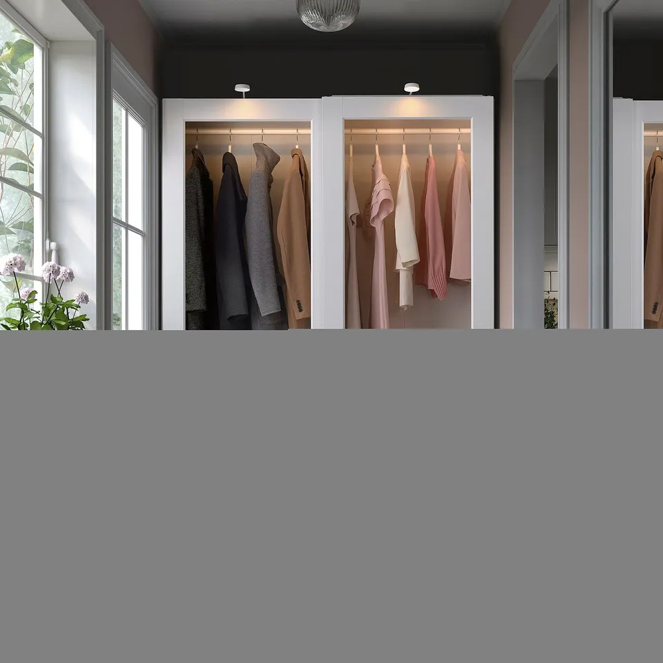 PAX wardrobe: modern glass & white, open & closed sections, neutral & pink clothes, lit from above, with windows & plants.