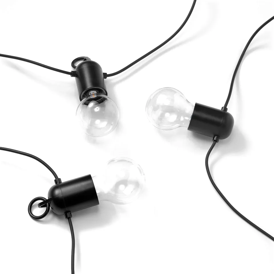 Three modern hanging lightbulbs with black fixtures on black cords, evenly spaced in a horizontal line.