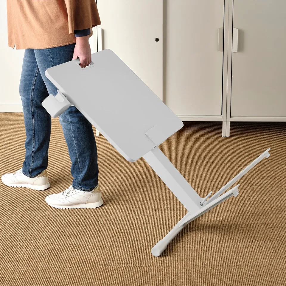 Person adjusting height of MITTZON laptop table.