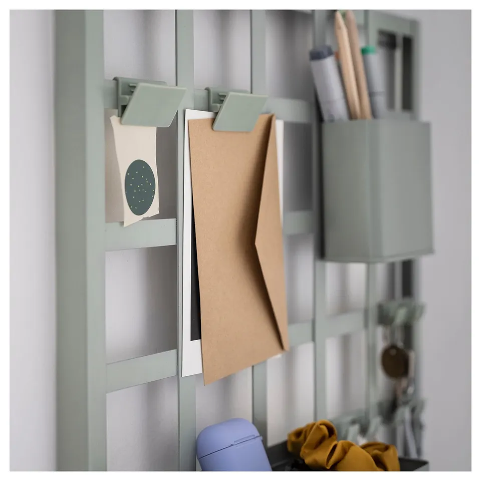 SNICKRA storage board with clips, hooks, and shelf in light green with accessories.
