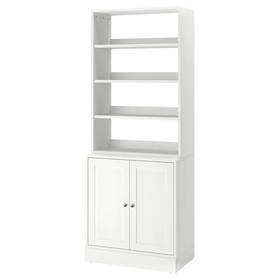 A white HAVSTA shelf unit made from solid pine, featuring open and closed storage spaces with a rustic design.