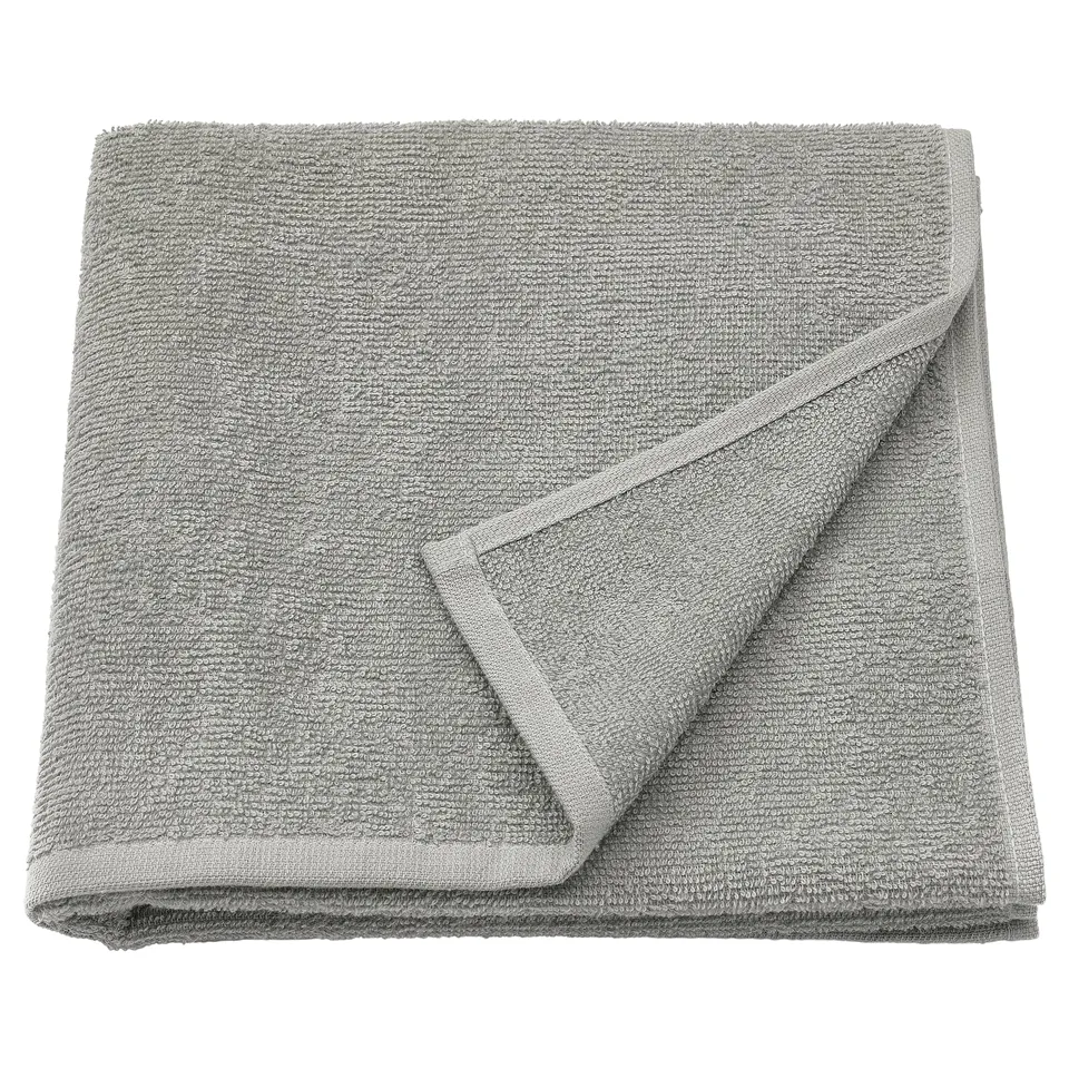Folded grey LUDDVIAL cotton towel, soft, lightweight, neatly folded square shape with visible terry texture.