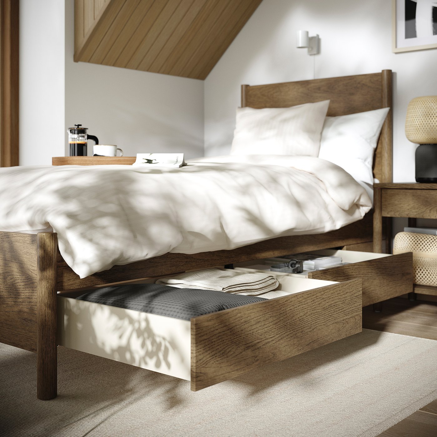 Modern bedroom with TONSTAD bed, linens in drawer, tray with coffee press, soft lighting.