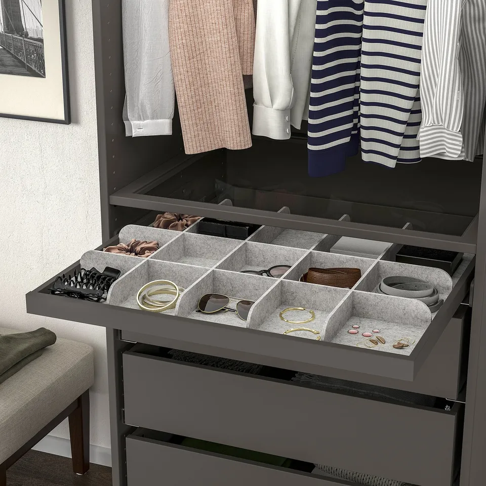 Organised wardrobe tray with compartments for accessories, featuring slow-close mechanism.