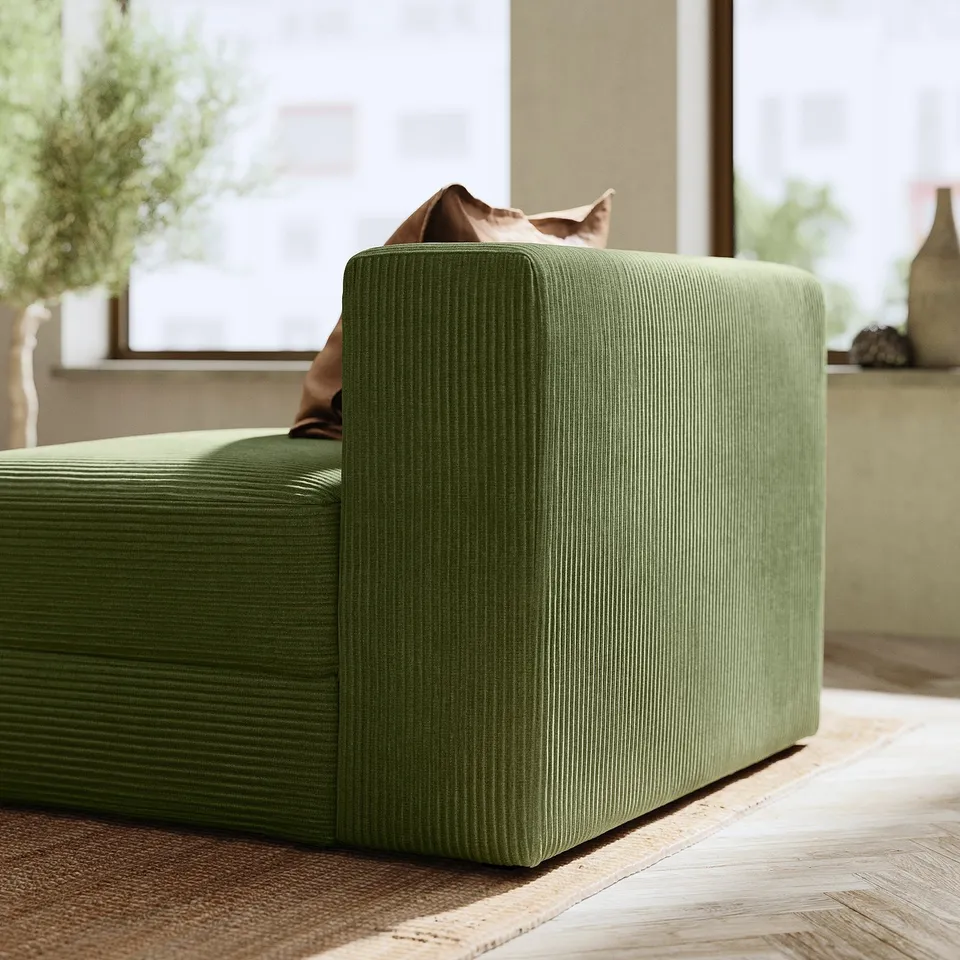 Modern living room with olive green, l-shaped, corduroy JÄTTEBO sectional sofa and cat on it.