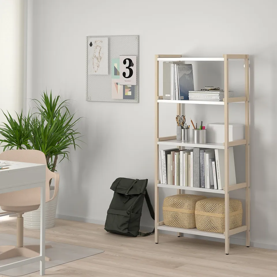 Bookshelf with laptop, books,-backpack & plant.