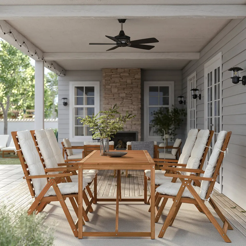 Black ceiling fan above wooden patio furniture.