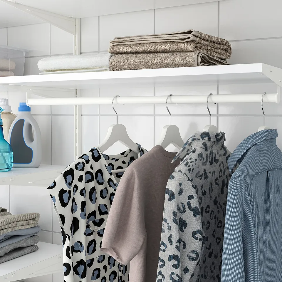Neat closet with clothes, towels, and detergent.