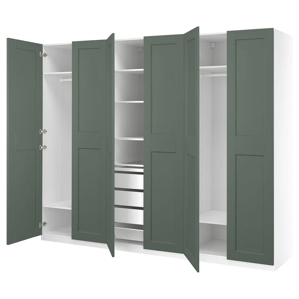 An open green PAX wardrobe with white shelves and partitions, displaying organised storage spaces.