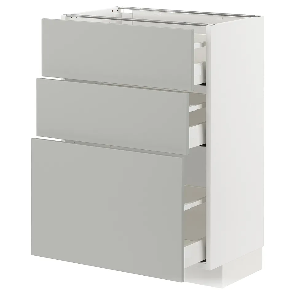 A white METOD kitchen cabinet with three light grey drawers and a shelf, made of particleboard and steel, featuring a modern clean design.