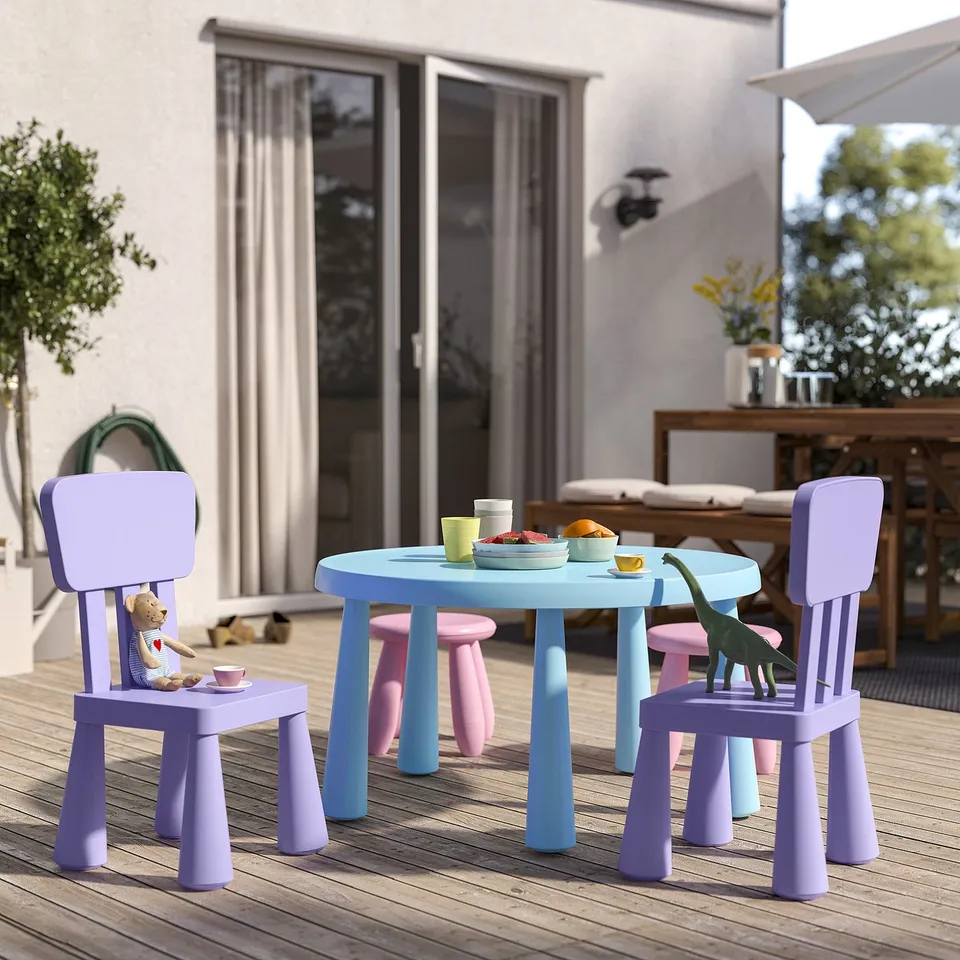 Small outdoor kids furniture set with purple chairs, blue table, and toy figures. Compact and colourful, perfect for play.
