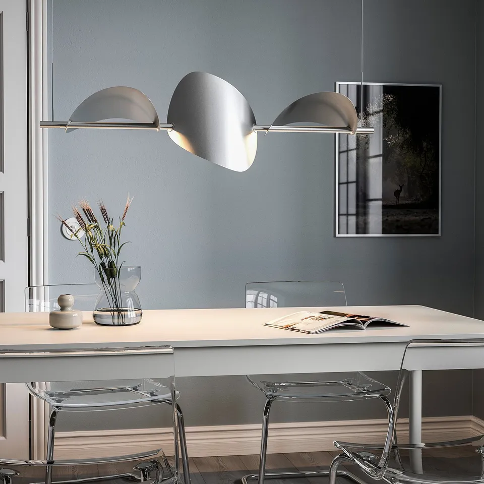 Modern dining area with BACKSTÖRN pendant lamp above white table and chairs, grey walls, and subtle decor.