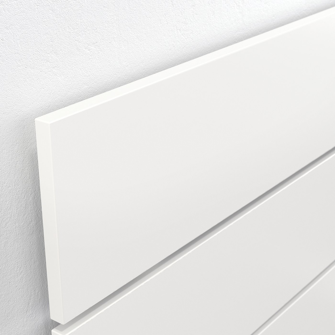 Crisp white corner detail of modern headboard, showing clean lines and smooth finish.
