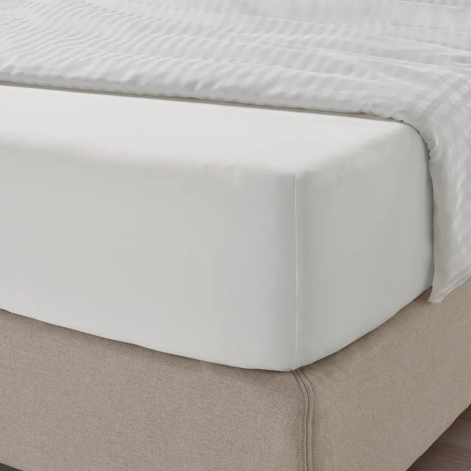 Close-up of crisp, white sheets with a lustrous finish. Silky texture and deep-pocket fit, ideal for thick mattresses.