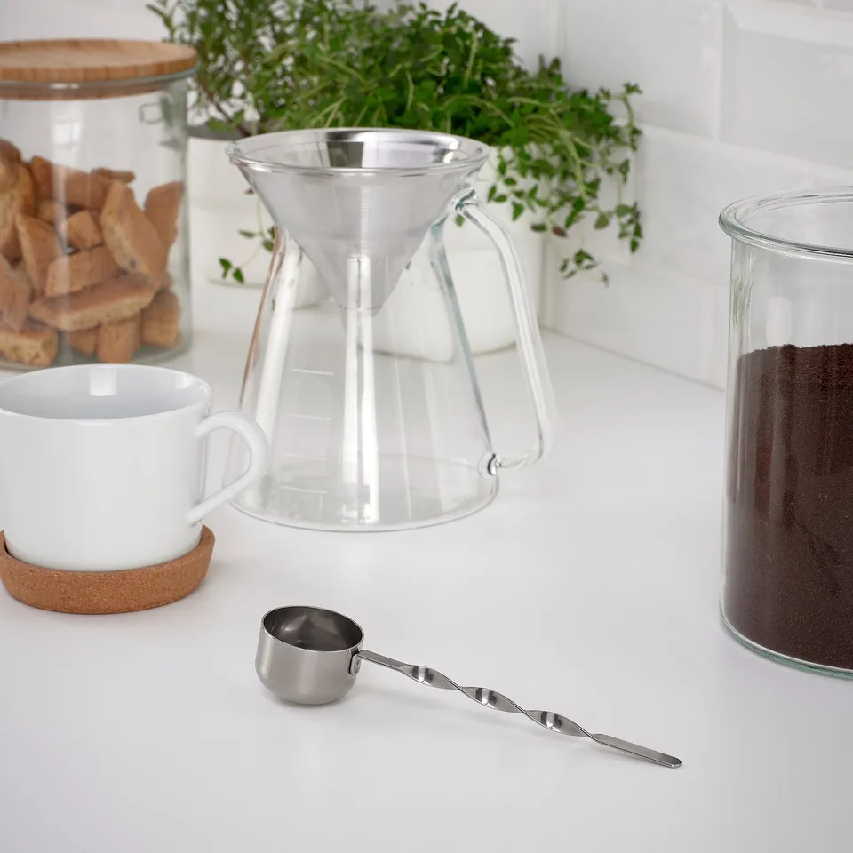Coffee setup: scoop, pour-over, mug, beans, cookies.