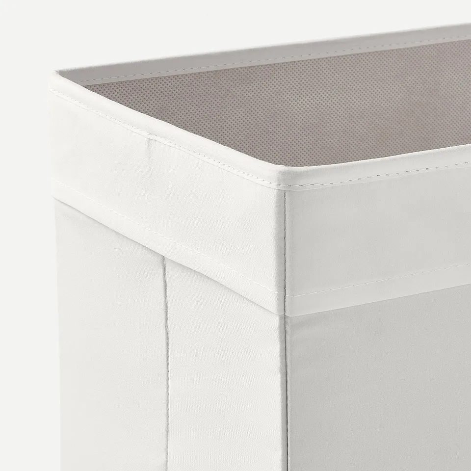 White fabric storage box with mesh top, sturdy construction, neat stitching.