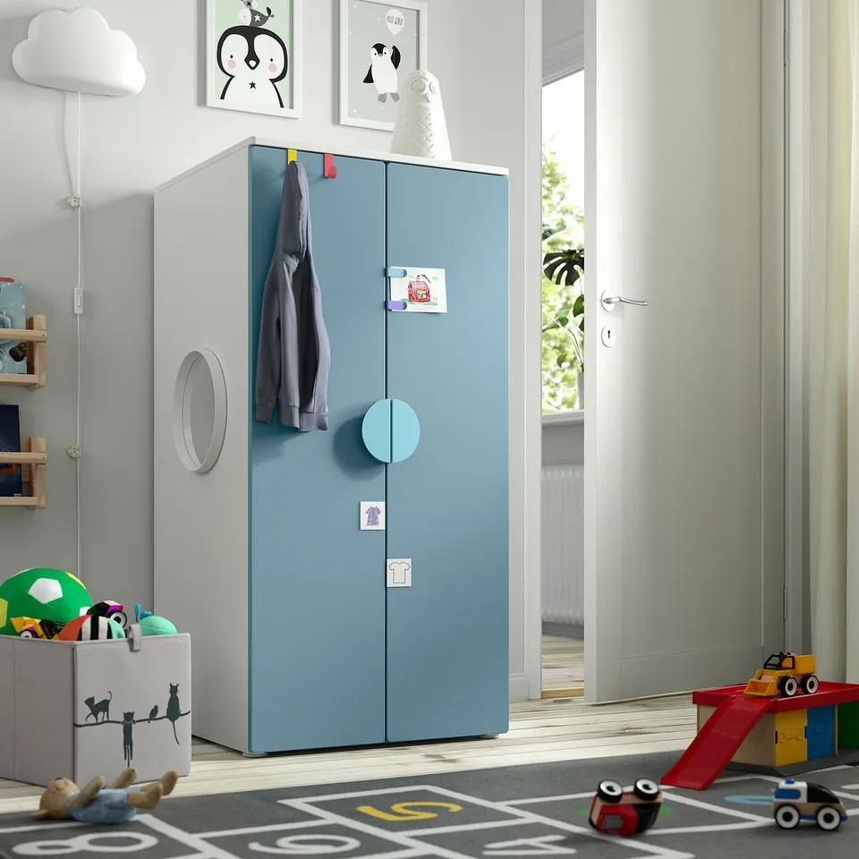 SMÅSTAD kids wardrobe with 2 doors, blue & modern design stands near white door, offers storage.