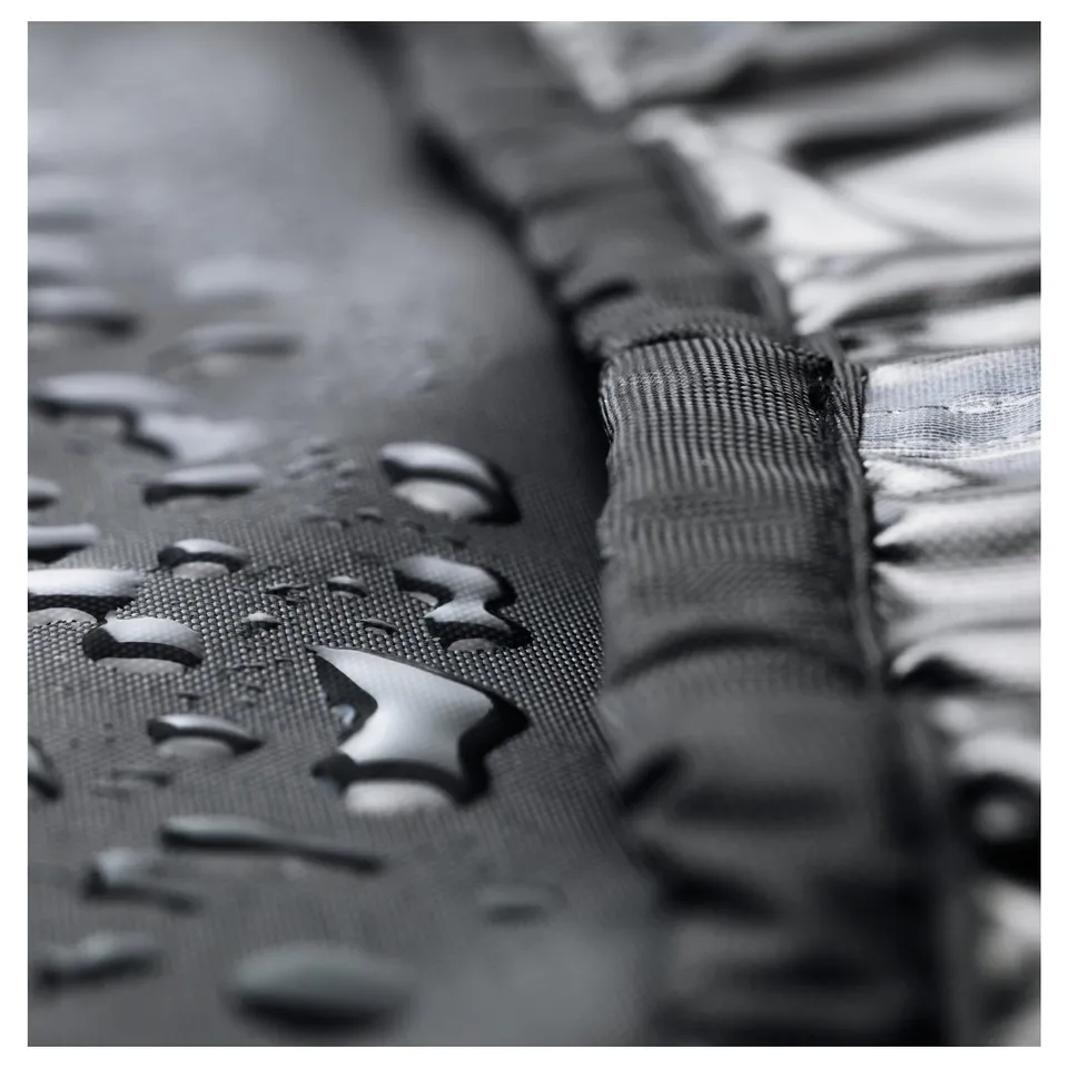 Water droplets bead on a garden furniture cover, demonstrating its waterproof protection.