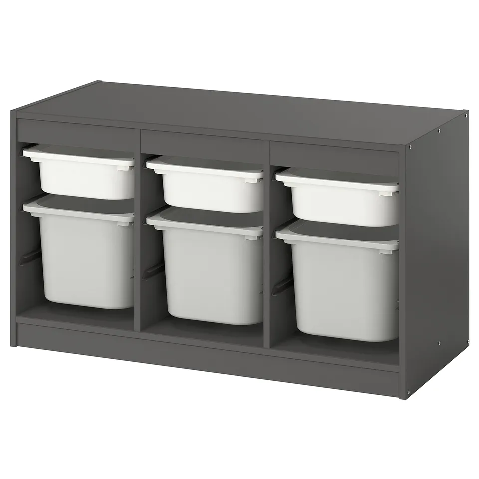 A TROFAST grey storage unit with white plastic bins, designed for children. It has a modern, organised look with adjustable compartments.