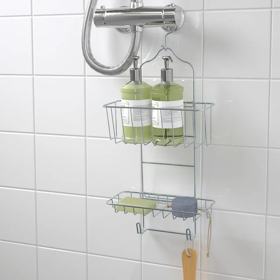 Metal shower caddy holds soap, shampoo, and has hooks; hangs without drilling.