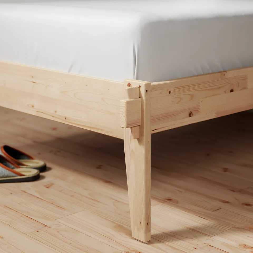 Minimalist light wood bed frame with slatted base, ideal for modern bedrooms.