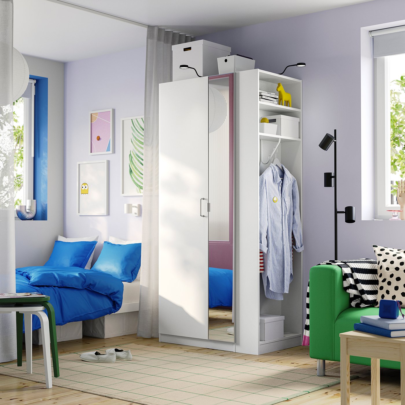 Modern bedroom with white PAX wardrobe, blue bed linens, green chair, wooden floor.