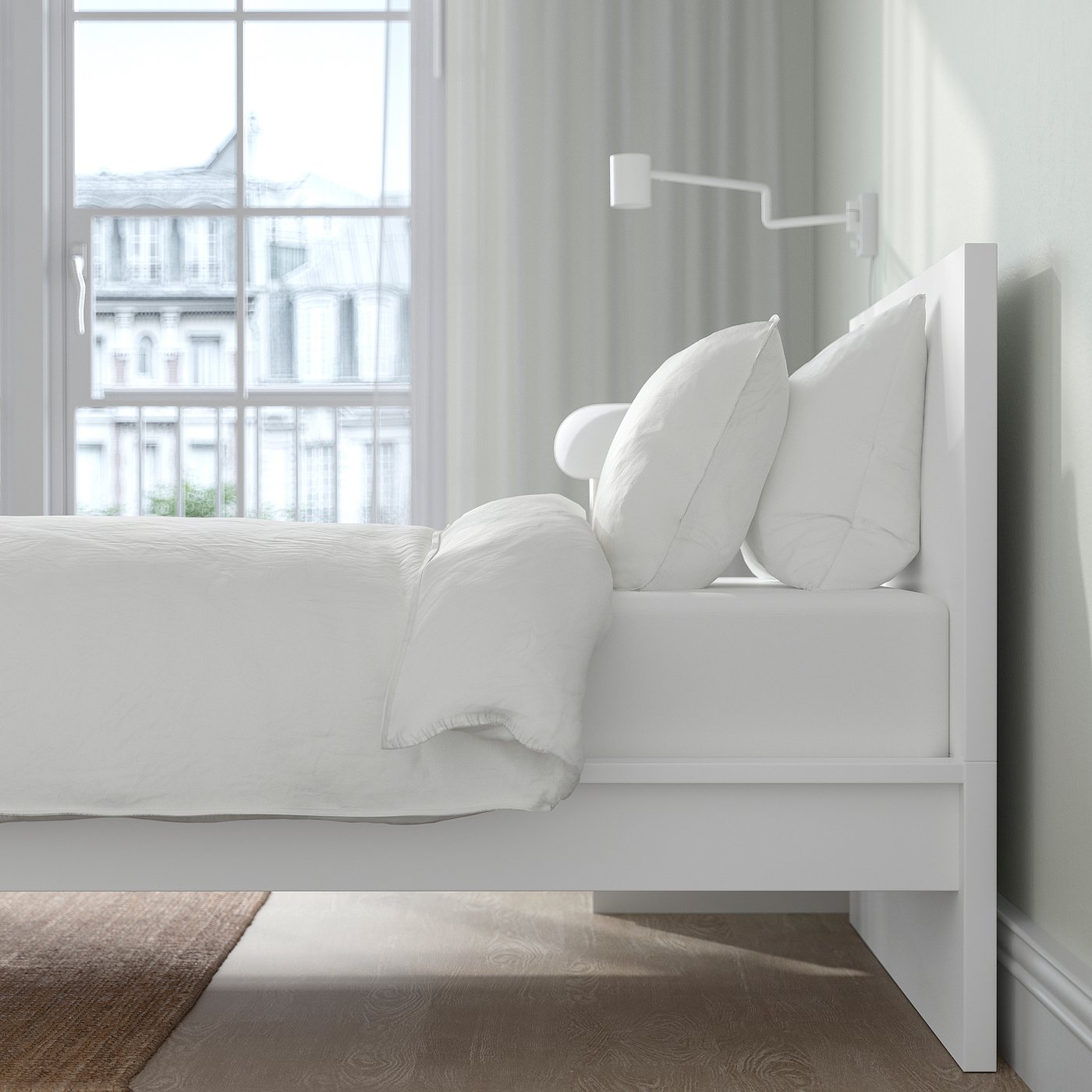 Bedroom scene with white MALM bed, pillows, and bedding near a large window offering city views.