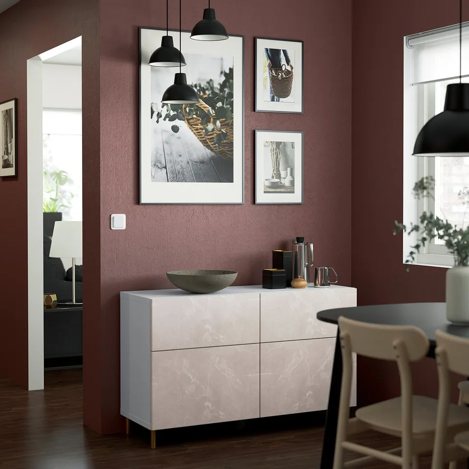 Modern living room with BESTÅ sideboard, photos, and lamps.