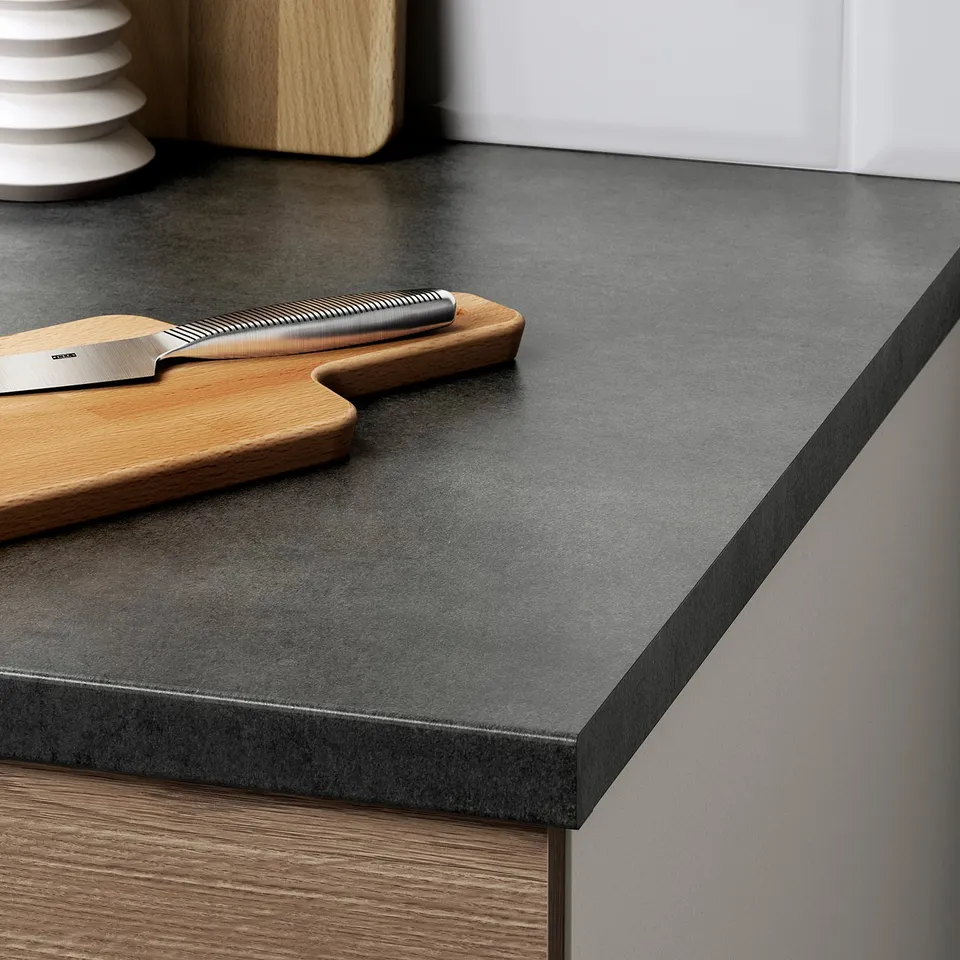 Kitchen counter with knife and cutting board, showing durable, easy-clean surface.