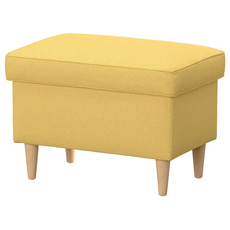 Bright yellow STRANDMON footstool with wooden legs, rectangular shape, soft cushioned top, and hidden storage inside.