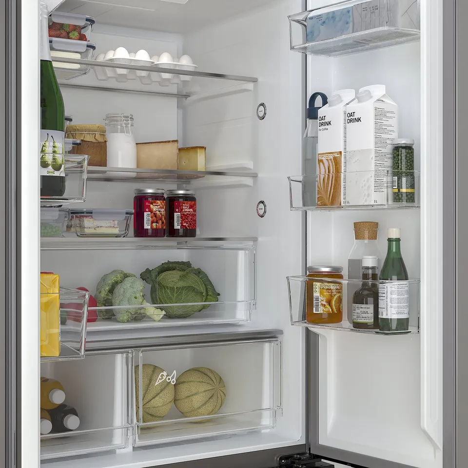 Organised fridge with glass shelves, led lighting, and compartments for produce, dairy, and drinks.