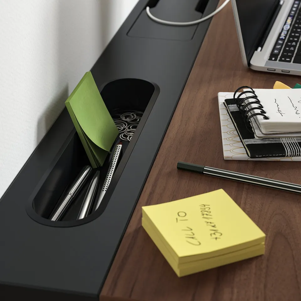 Organised desk setup with MITTZON height-adjustable desk, pens, and sticky notes.