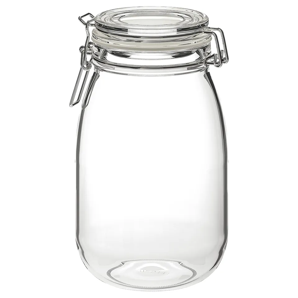 A KORKEN glass jar with a clear, airtight rubber seal and stainless steel wire clamp. Its round, transparent, and designed for food storage.