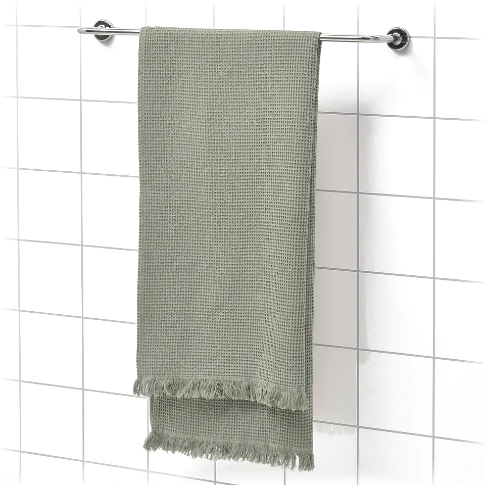 Green VALLASÅN towel with fringe on chrome bar, soft & absorbent, 80% cotton, 20% viscose.