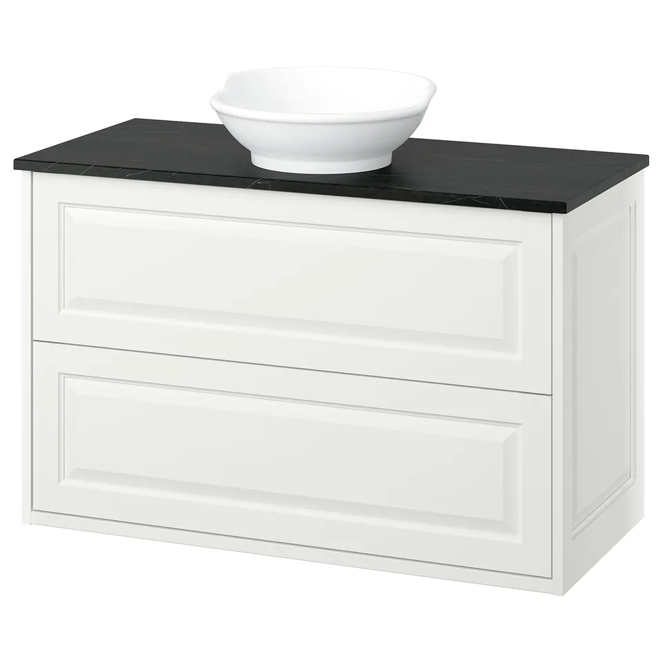 White TÄNNFORSEN bathroom vanity, rounded washbasin, black countertop, soft edges.