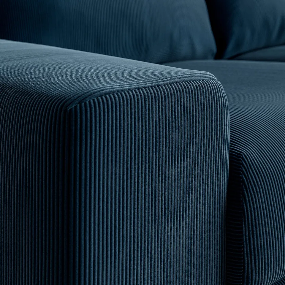 Close-up of VIMLE sofas armrest, showcasing its textured, ribbed dark blue corduroy fabric and plush, inviting cushioning.